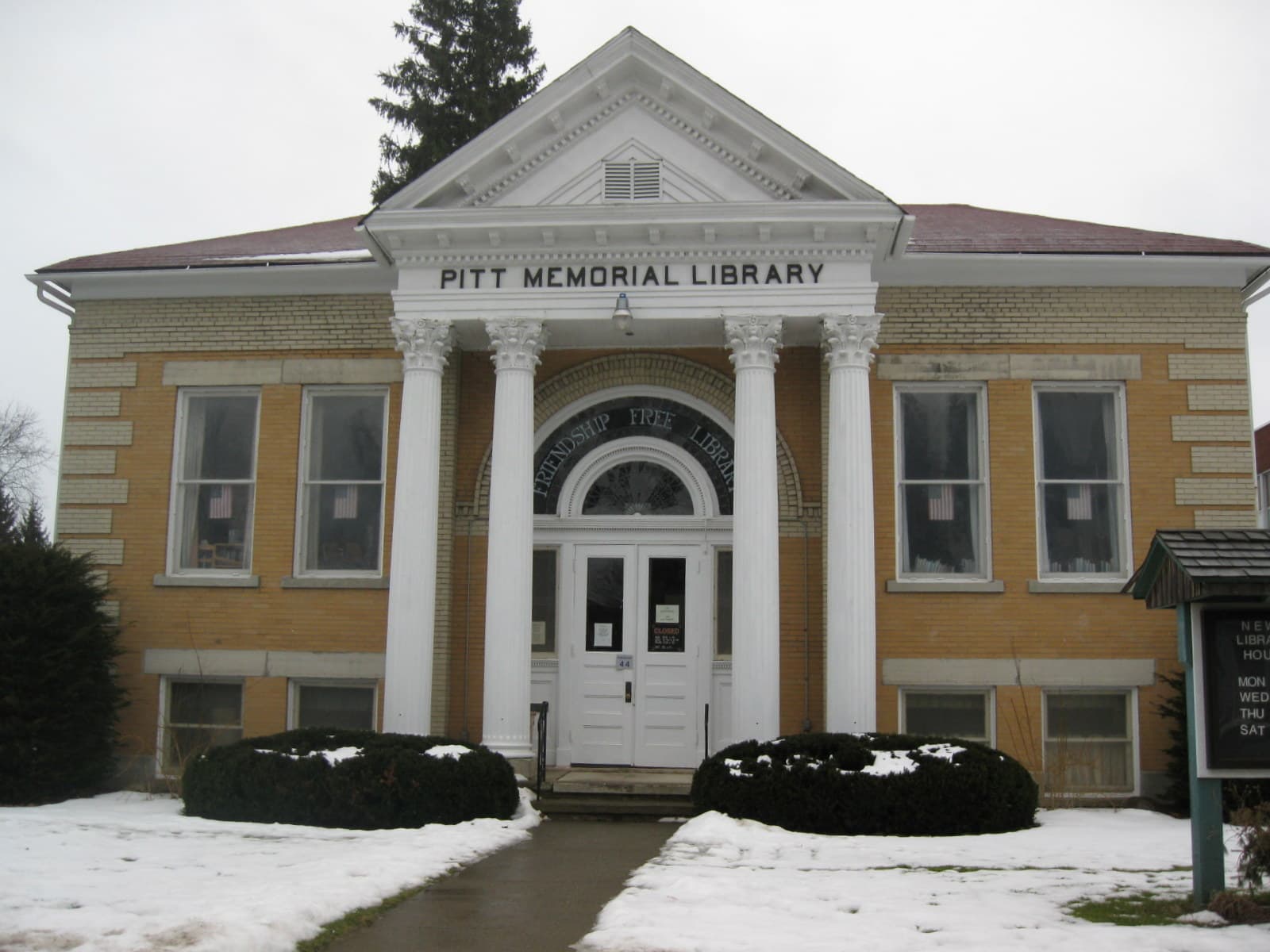 The yellow-brick Friendship Free Library (Pitt Memorial Library) building in Friendship, New York